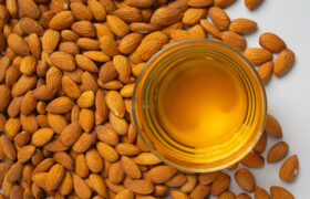 Almond oil in bottle on white background
